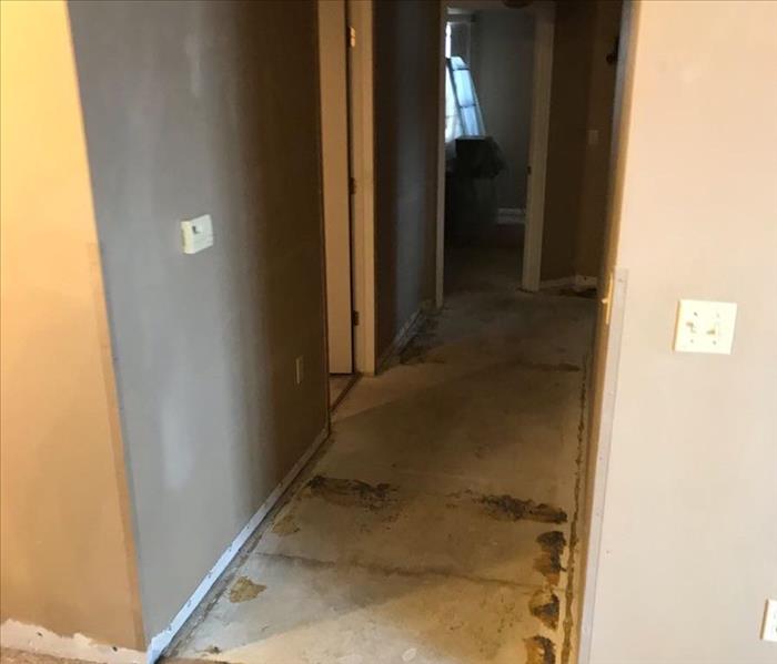after carpet and drywall removed from hallway of condo 
